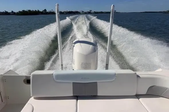 Slide: The Image of 2020 Robalo R242 Explorer boat cruising on open water, view from the stern. - 3