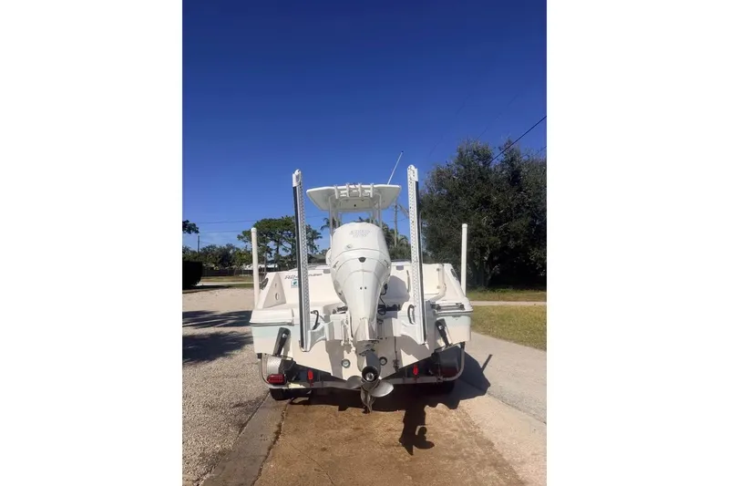 Slide: The Image of 2020 Robalo R242 Explorer boat, rear view with outboard motor, parked outdoors. - 8