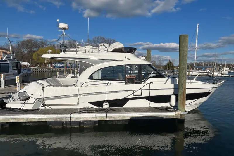 The Image of 2025 Beneteau Antares 11 Fly yacht docked at marina under blue sky. - 1