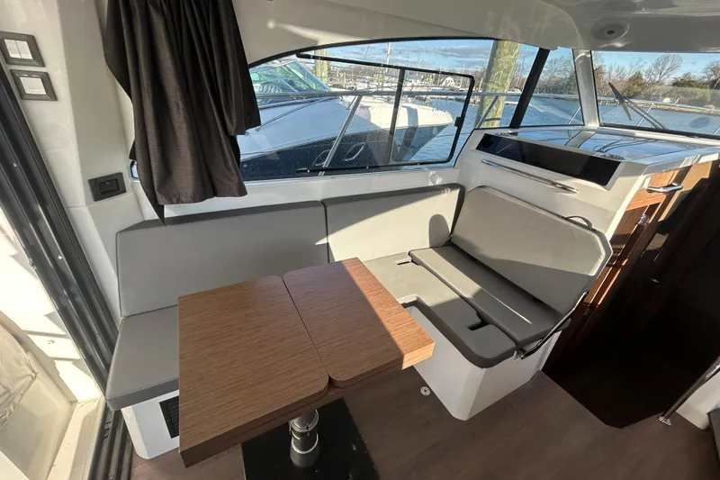 Slide: The Image of Interior of 2025 Beneteau Antares 11 Fly with seating and wooden table. - 5
