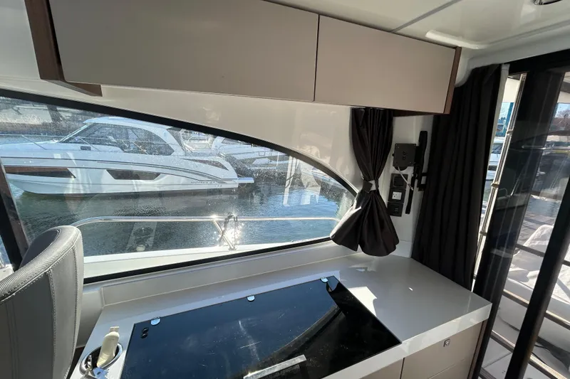 Slide: The Image of Interior view of 2025 Beneteau Antares 11 Fly, featuring sleek design and waterfront scenery. - 6