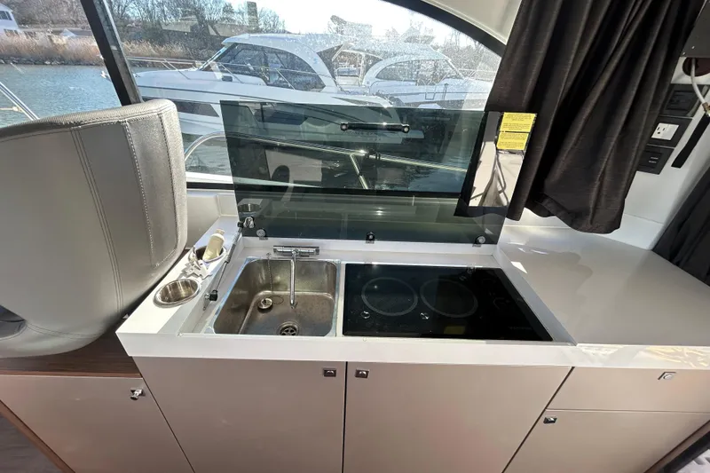 Slide: The Image of Modern kitchen area in 2025 Beneteau Antares 11 Fly yacht with sink and stove. - 7