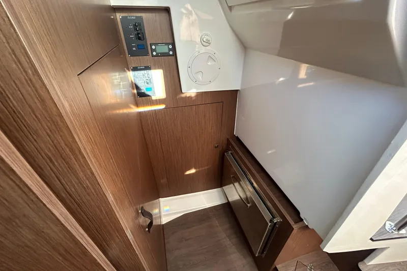 Slide: The Image of Interior of 2025 Beneteau Antares 11 Fly, featuring wood paneling and modern controls. - 8