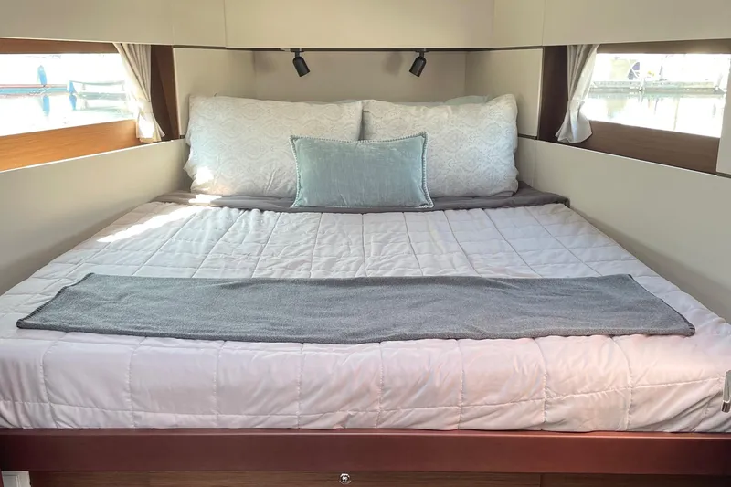 Slide: The Image of Luxurious vee berth interior of 2022 Beneteau Oceanis 38.1 yacht with cozy bedding - 2