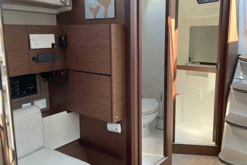 Slide: The Image of Interior of 2022 Beneteau Oceanis 38.1 yacht showing nav station (table up), head, and shower compartment - 29