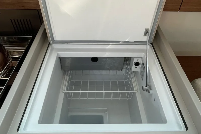 Slide: The Image of Open fridge/freezer compartment in 2022 Beneteau Oceanis 38.1 yacht galley - 30
