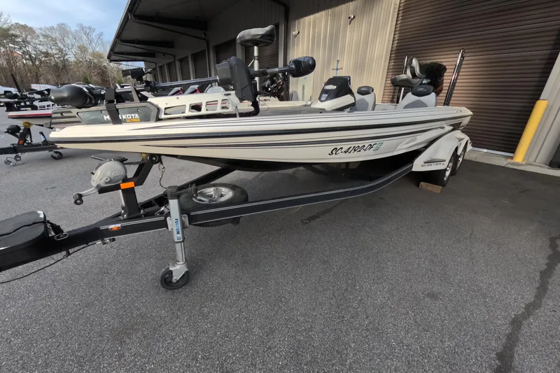 Slide: The Image of 2015 Skeeter FX21 fishing boat on trailer, parked outside a building. - 3