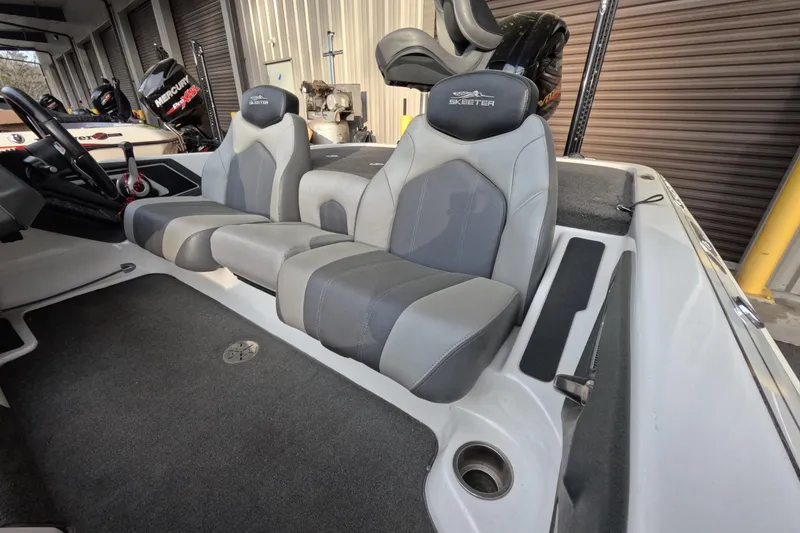 Slide: The Image of 2015 Skeeter FX21 boat interior with gray seating and steering wheel. - 5