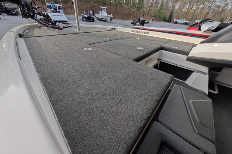 Slide: The Image of 2015 Skeeter FX21 boat deck with storage compartments and fishing equipment. - 6
