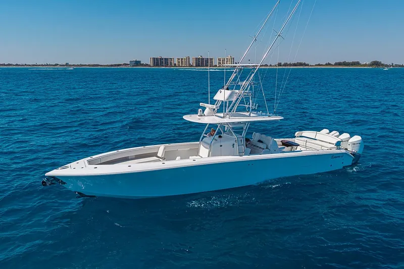 Slide: The Image of 2017 Bahama 41 boat cruising on blue ocean near coastline buildings. - 1