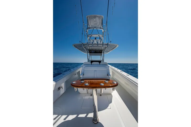 Slide: The Image of 2017 Bahama 41 boat with tower and seating, cruising on open sea under clear blue sky. - 14