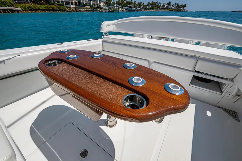Slide: The Image of Luxurious 2017 Bahama 41 boat with elegant wooden table on deck, overlooking serene blue waters. - 18