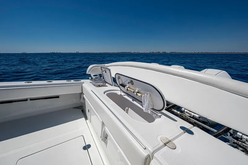 Slide: The Image of 2017 Bahama 41 boat with open deck and ocean view under clear blue sky. - 19