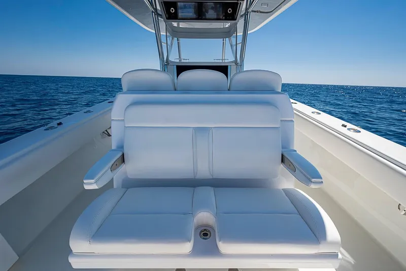 Slide: The Image of 2017 Bahama 41 boat with white seating, ocean view, and clear blue sky. - 21