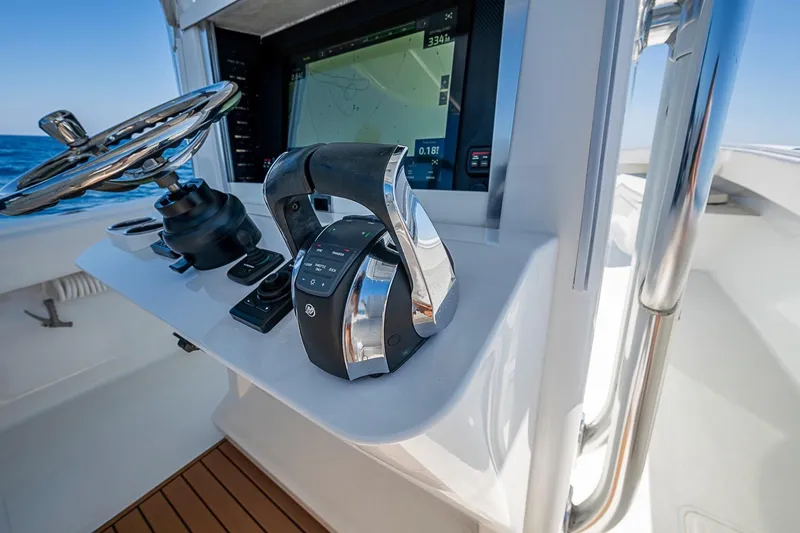 Slide: The Image of Control panel of a 2017 Bahama 41 boat with steering wheel and navigation display. - 29
