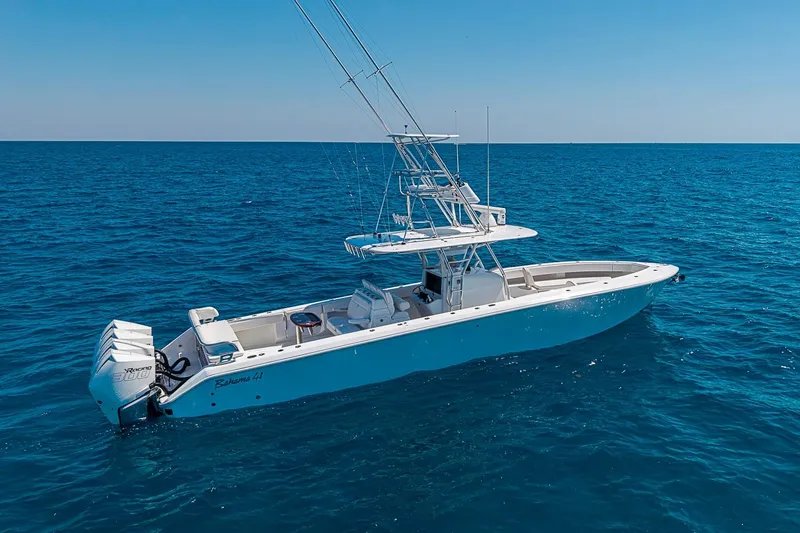 Slide: The Image of 2017 Bahama 41 boat on open ocean, featuring triple outboard engines. - 3
