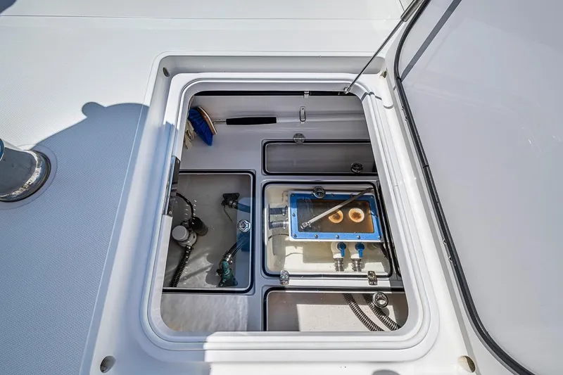Slide: The Image of Open storage compartment on 2017 Bahama 41 boat, showcasing organized equipment and tools. - 34