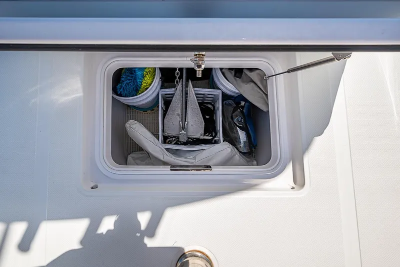Slide: The Image of Storage compartment on a 2017 Bahama 41 boat, containing anchor and cleaning supplies. - 36