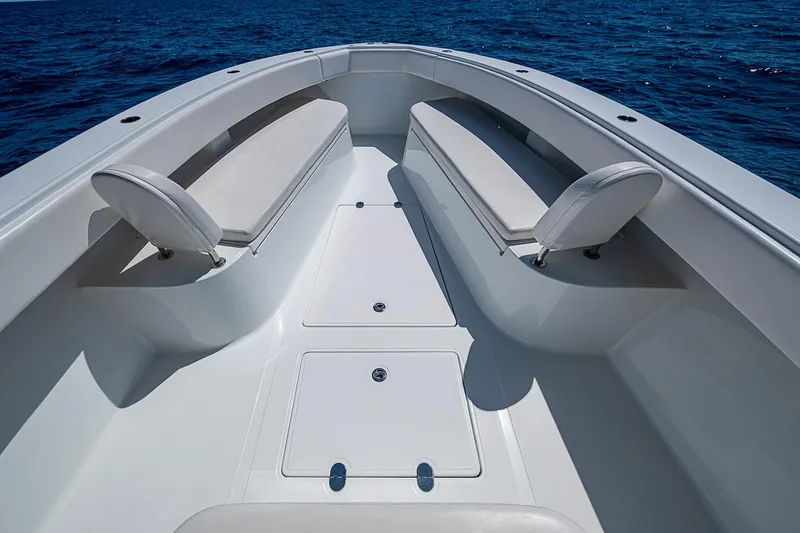 Slide: The Image of 2017 Bahama 41 boat interior with white seating, open deck, and ocean backdrop. - 39