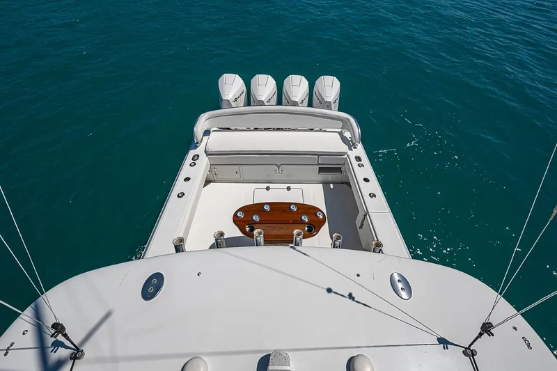 Slide: The Image of 2017 Bahama 41 boat with four engines, spacious deck, and fishing setup on blue water. - 47