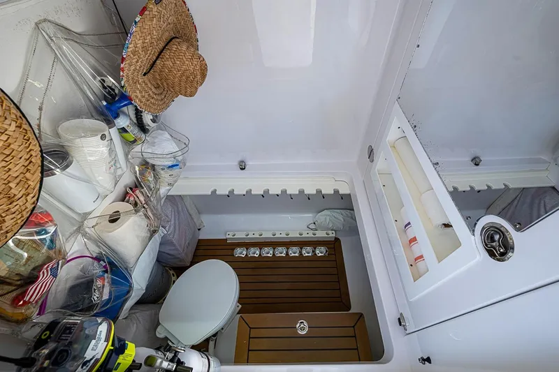 Slide: The Image of Interior of 2017 Bahama 41 boat with storage, toilet, and wooden flooring. - 49