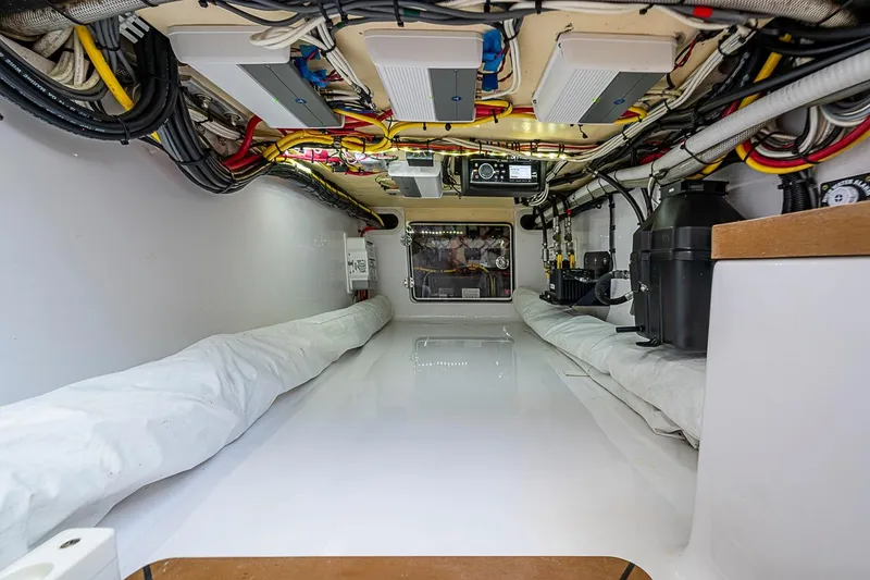 Slide: The Image of Engine room of a 2017 Bahama 41 boat, showcasing wiring and equipment. - 51