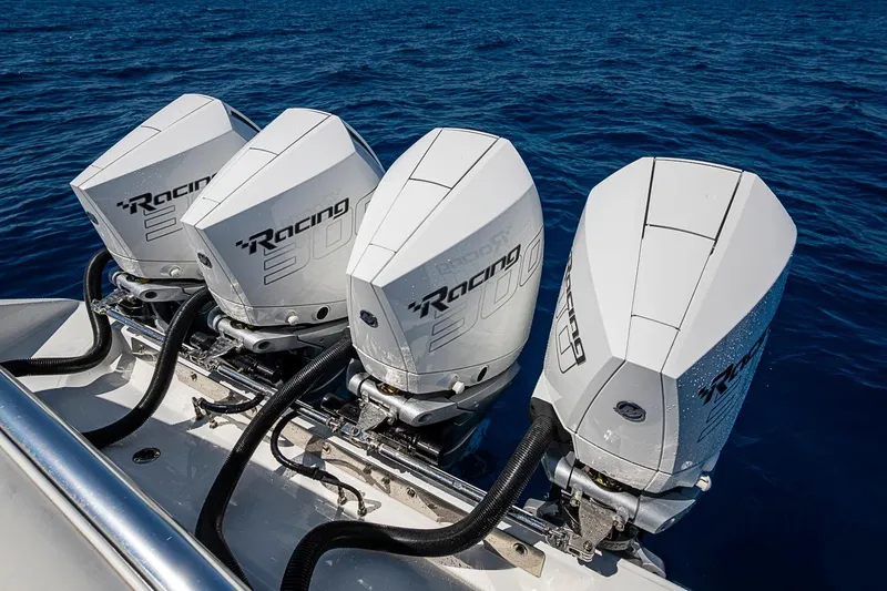 Slide: The Image of Four powerful outboard engines on a 2017 Bahama 41 boat in open water. - 52