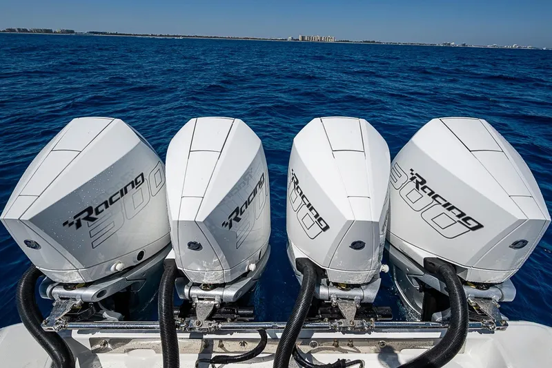 Slide: The Image of Four powerful outboard engines on a 2017 Bahama 41 boat, cruising on open blue waters. - 53