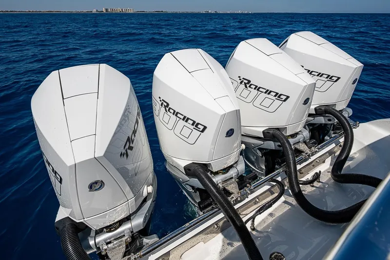 Slide: The Image of Four powerful outboard engines on a 2017 Bahama 41 boat, cruising in open blue waters. - 54