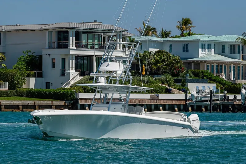Slide: The Image of 2017 Bahama 41 boat cruising near luxury waterfront homes. - 9