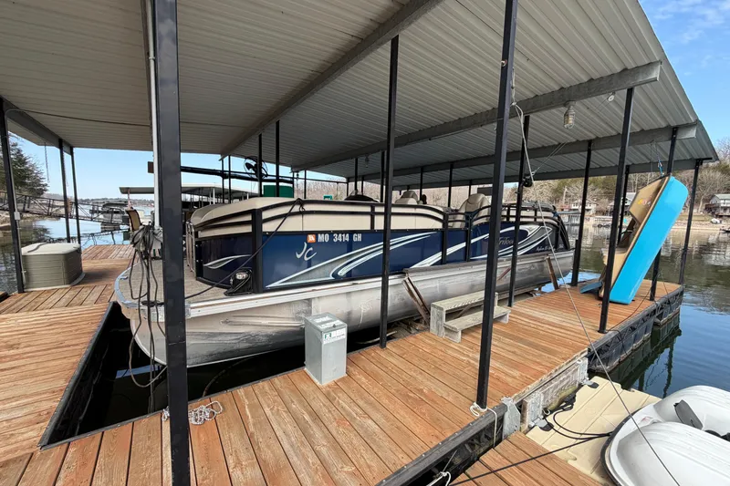 The Image of 2018 JC 25 Neptoon TT Sport pontoon boat docked under covered marina. - 1