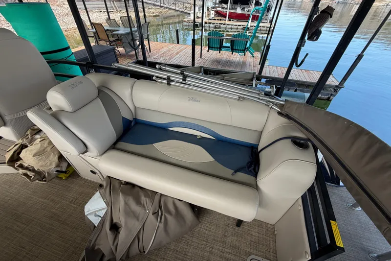 Slide: The Image of 2018 JC 25 Neptoon TT Sport boat interior with beige seating and dock view. - 13