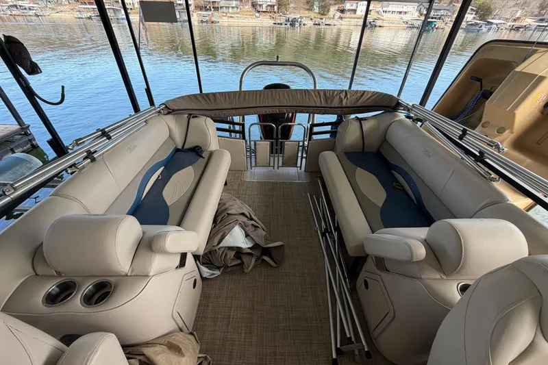 Slide: The Image of 2018 JC 25 Neptoon TT Sport pontoon boat interior with beige seating and lake view. - 18