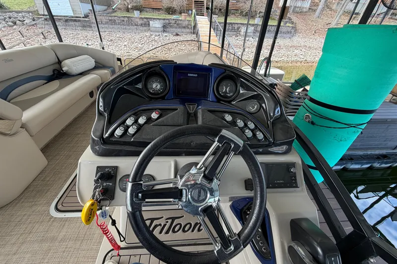 Slide: The Image of 2018 JC 25 Neptoon TT Sport boat dashboard with steering wheel and controls. - 20