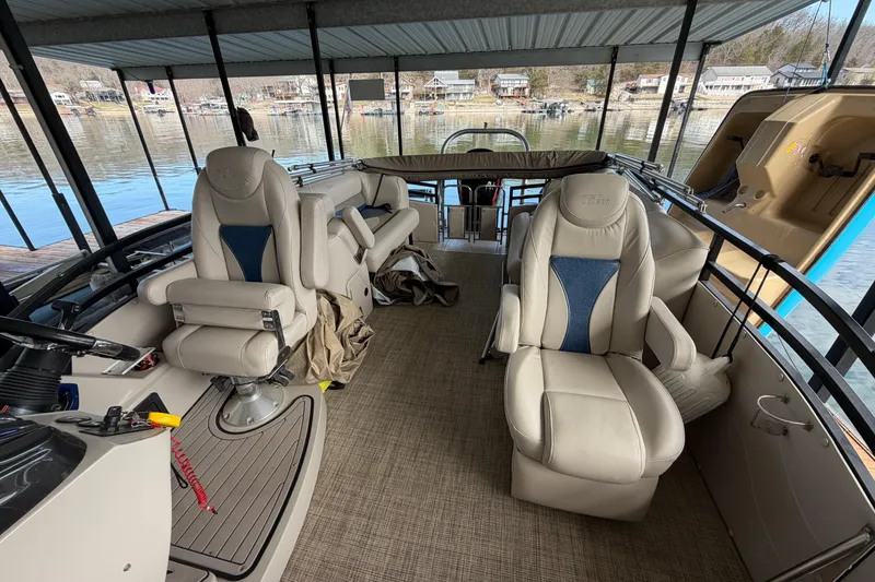 Slide: The Image of 2018 JC 25 Neptoon TT Sport boat interior with plush seating and lake view. - 23