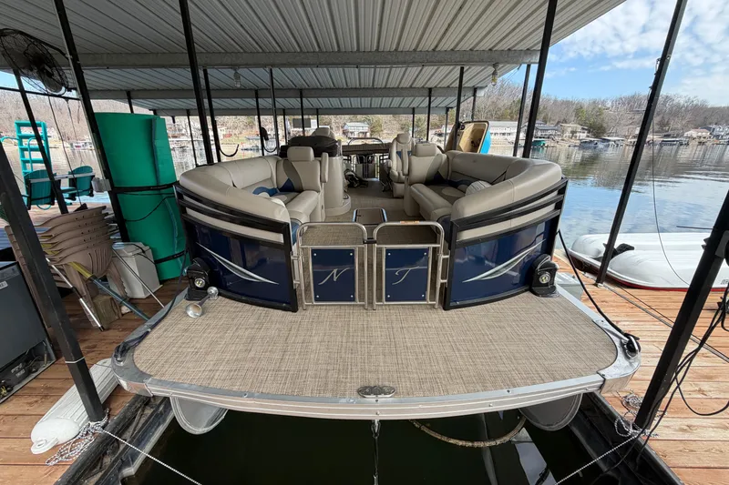 Slide: The Image of 2018 JC 25 Neptoon TT Sport pontoon boat docked under covered marina. - 3