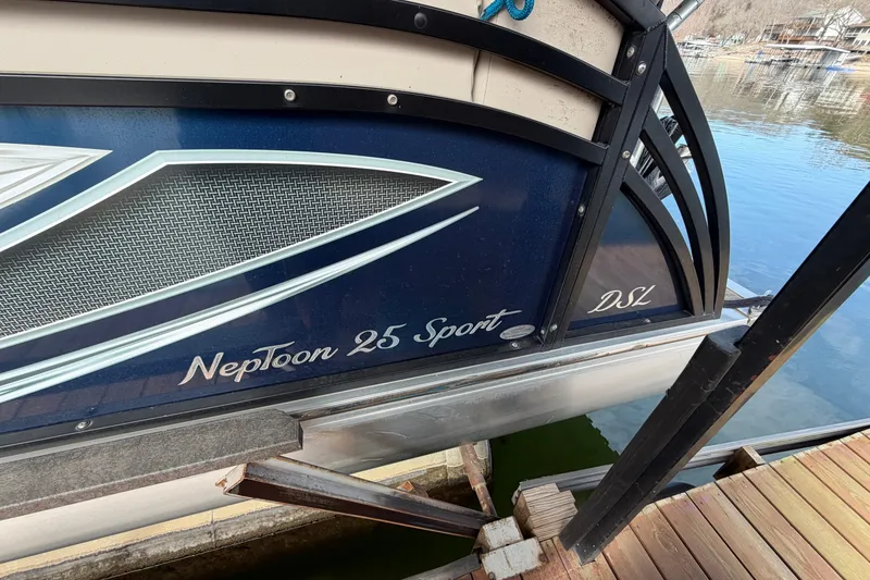 Slide: The Image of 2018 JC 25 Neptoon TT Sport pontoon boat docked by the water. - 5