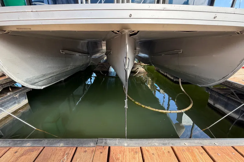 Slide: The Image of Underneath view of a 2018 JC 25 Neptoon TT Sport pontoon boat docked. - 9