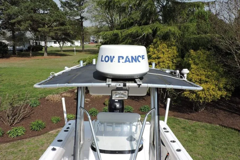 Slide: The Image of 2007 Sea Fox 216 Center Console boat with radar, surrounded by lush greenery. - 19
