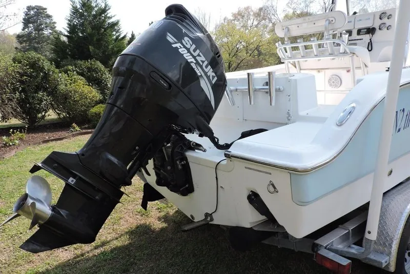 Slide: The Image of 2007 Sea Fox 216 Center Console boat with Suzuki outboard motor on trailer. - 2