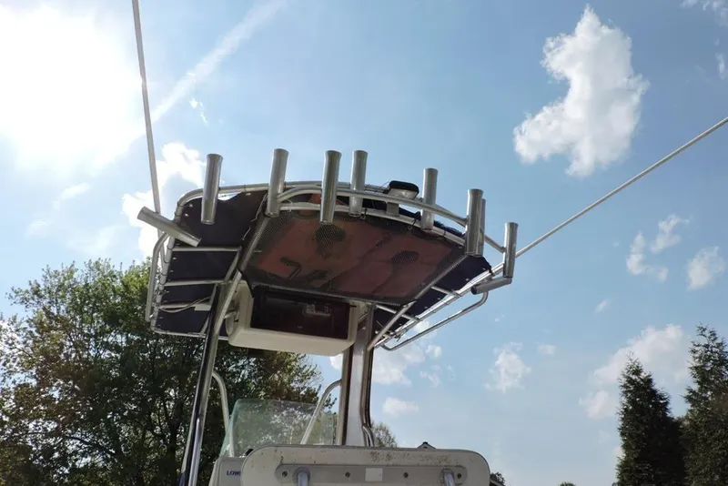 Slide: The Image of 2007 Sea Fox 216 Center Console boat with rod holders under a clear sky. - 34