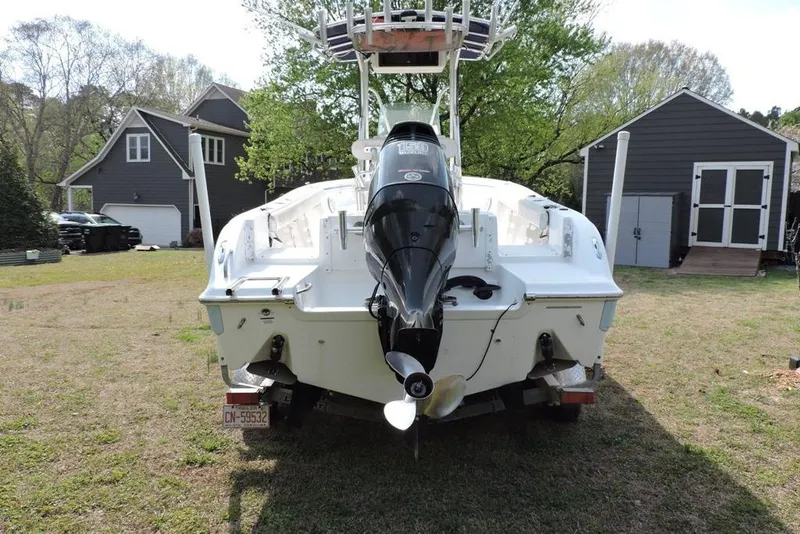 Slide: The Image of 2007 Sea Fox 216 Center Console boat with outboard motor, parked on grass. - 5
