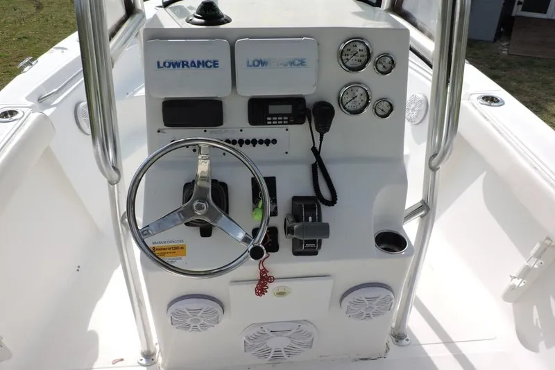 Slide: The Image of Center console of a 2007 Sea Fox 216 boat with steering wheel and gauges. - 9