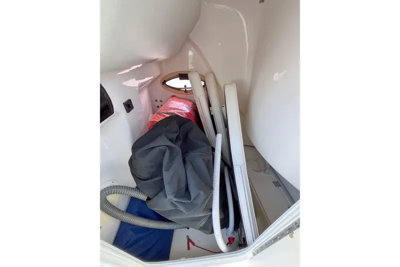 Slide: The Image of 2008 Robalo R260 Center Console interior storage area with equipment and supplies. - 12