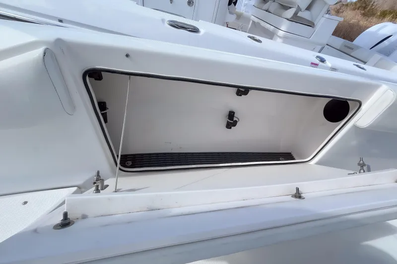 Slide: The Image of Open storage compartment on a 2008 Robalo R260 Center Console boat. - 13