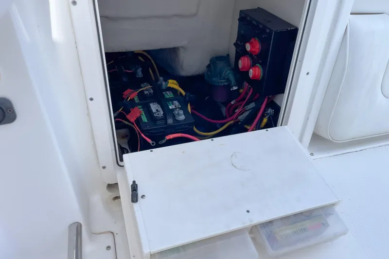 Slide: The Image of 2008 Robalo R260 Center Console boat battery compartment with wiring and switches. - 14
