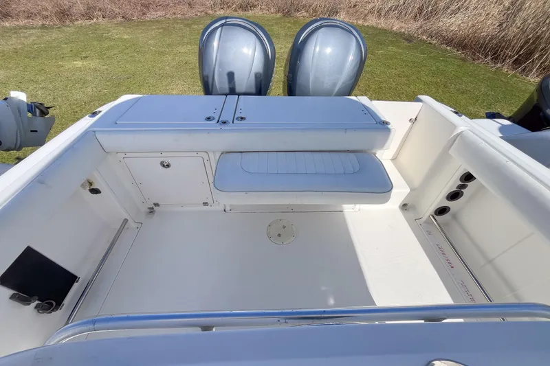 Slide: The Image of 2008 Robalo R260 Center Console boat interior with seating and storage compartments. - 2