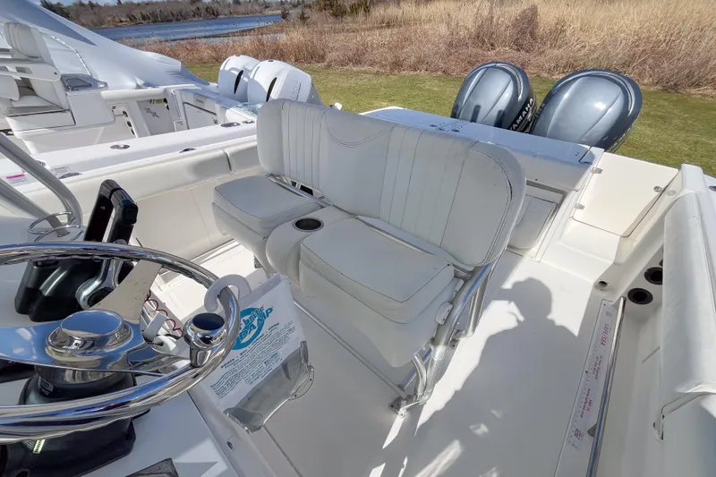 Slide: The Image of 2008 Robalo R260 Center Console boat interior with dual Yamaha engines and white seating. - 5