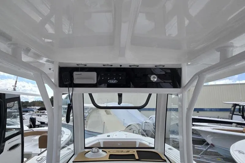 Slide: The Image of Interior view of 2026 Sea Hunt Ultra 265 SE boat dashboard and controls. - 12