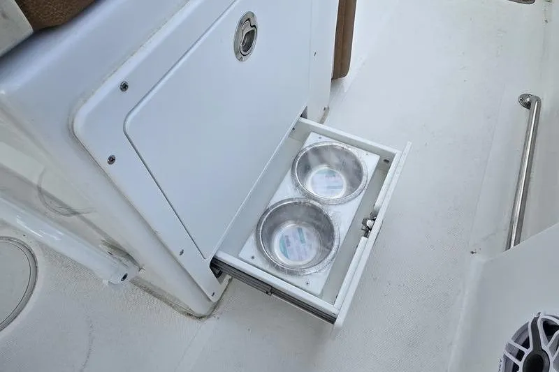 Slide: The Image of Built-in pet feeding station on 2026 Sea Hunt Ultra 265 SE boat. - 13